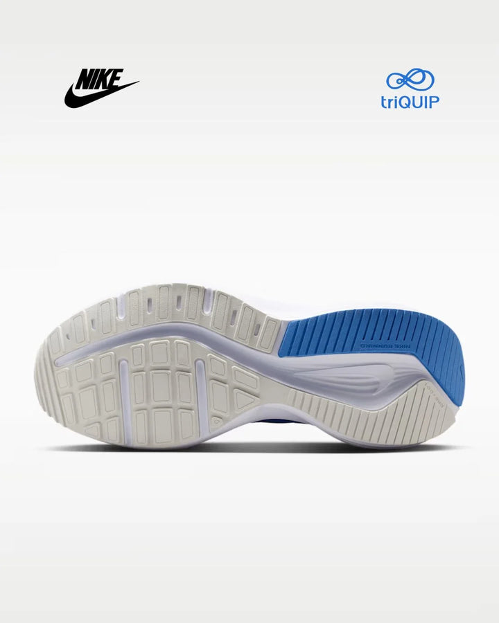 A Nike running shoe sole shown from the bottom, featuring a white and light gray textured tread with a bright blue heel section. The Nike swoosh is visible in the top left, and the triQUIP logo is visible in the top right, all on a clean white background.